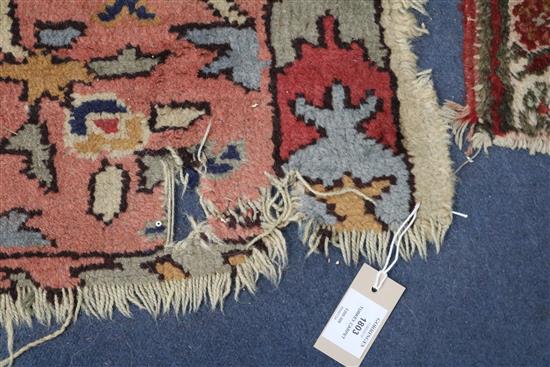 A Turkey pink and cream medallion carpet (worn in places and frayed at one end) 410 x 313cm